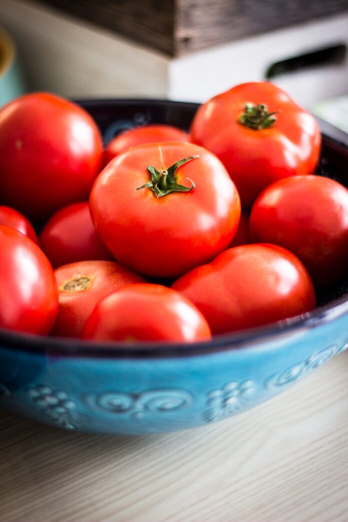 Photo by Deniz Altindas a bowl of red tomatoes