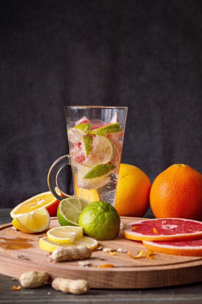 Photo by Yana clear glass mug with orange fruits