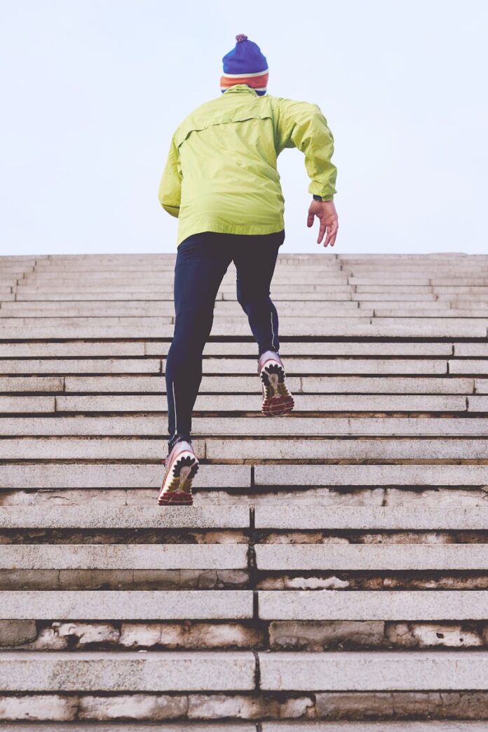 Photo by Clique Images person climbing concrete stairs