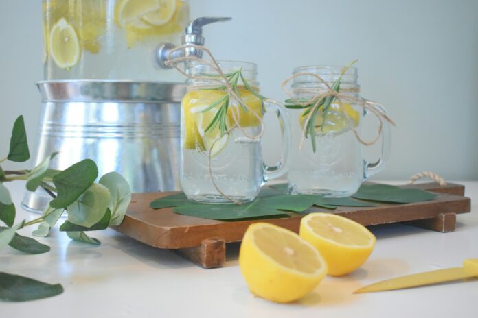 Photo by Mariah Hewines a couple of lemons sitting on top of a cutting board
