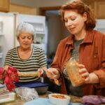 여성 건강, 일상에서 지키는 똑똑한 실천법 Two women preparing food in a kitchen.