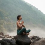 여성 건강관리, 일상 속 작은 변화가 만드는 큰 차이 a woman sitting on top of a rock next to a river