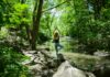 필라테스, 내 몸과 마음을 단련하는 생활 속 건강 습관으로 주목 woman in blue tank top and blue leggings standing on gray rock near river during daytime